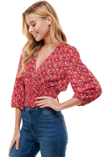 Veronica Long sleeve blouse in Red floral print. Plunging neck line with smocking at waist.