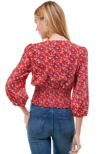 Veronica Long sleeve blouse in Red floral print. Plunging neck line with smocking at waist.